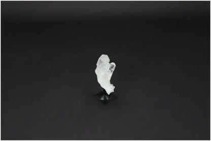 Lemurian Quartz on metal stand, known for purifying energy and neutralizing negative vibrations; ideal for harmonizing mind and space.