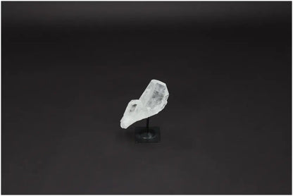 Lemurian Quartz on metal stand against dark background, ideal for energy purification and harmonizing space.