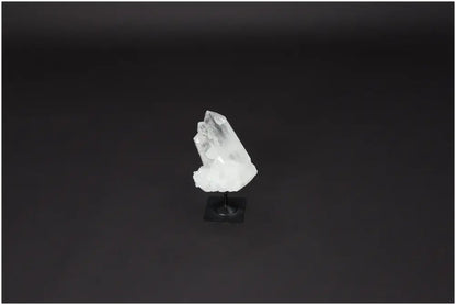 Lemurian Quartz crystal on a metal stand against a dark background, used for energy purification and harmonic balance.
