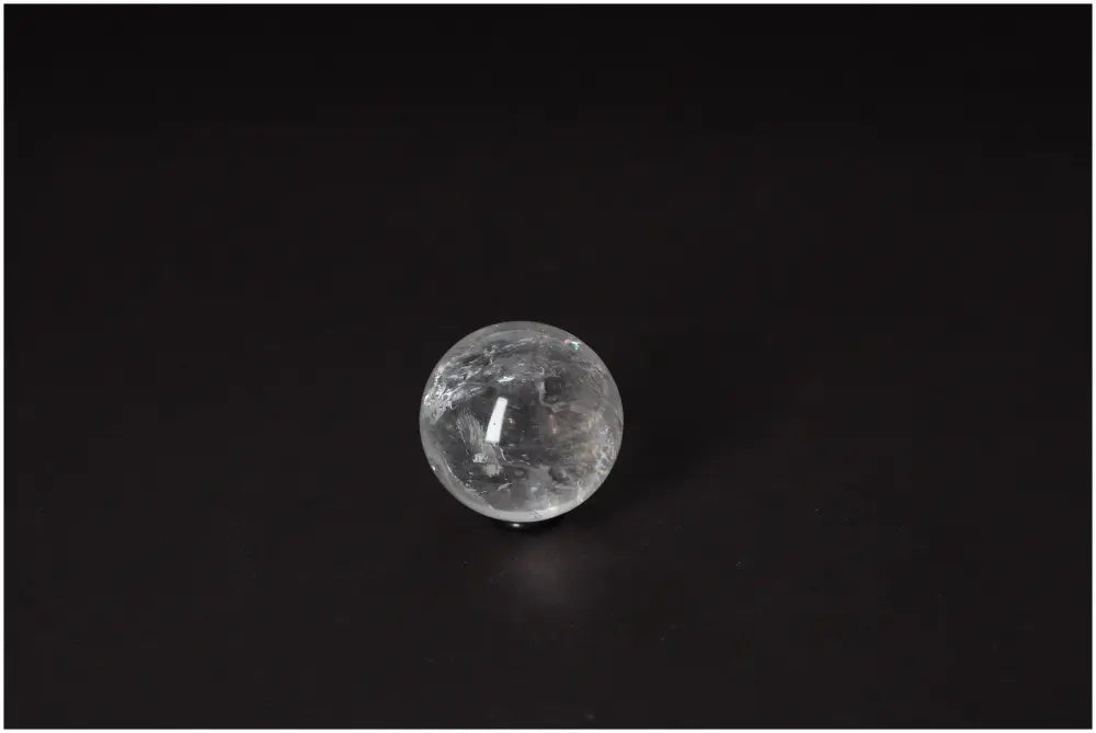 Lemurian Quartz Sphere 4-5 CM displaying radiant energy and ancient wisdom on a dark background.