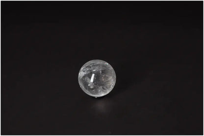 Lemurian Quartz Sphere 4-5 CM displaying radiant energy and ancient wisdom on a dark background.