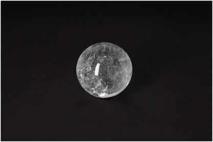 Lemurian Quartz Sphere with radiant energy and spiritual growth properties on black background, 6-7 CM in diameter.