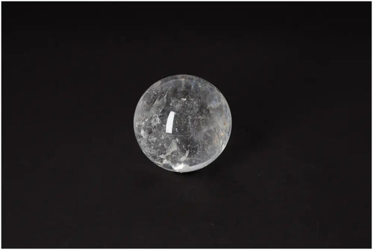 Lemurian Quartz Sphere with radiant energy and spiritual growth properties on black background, 6-7 CM in diameter.