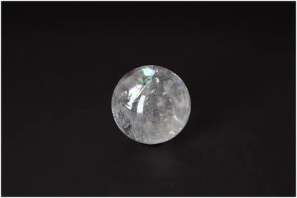 Clear Lemurian Quartz Sphere 6-7 CM on black background, showcasing high-vibrational energy and luminous clarity for spiritual growth.