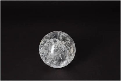 Lemurian Quartz Sphere 7-8 CM with radiant energy, known for spiritual growth and intuitive wisdom, on a dark background.