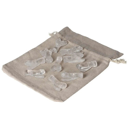 Clear Quartz Lemurian Small Angel crystals on a beige cloth bag for energy cleansing and purification.