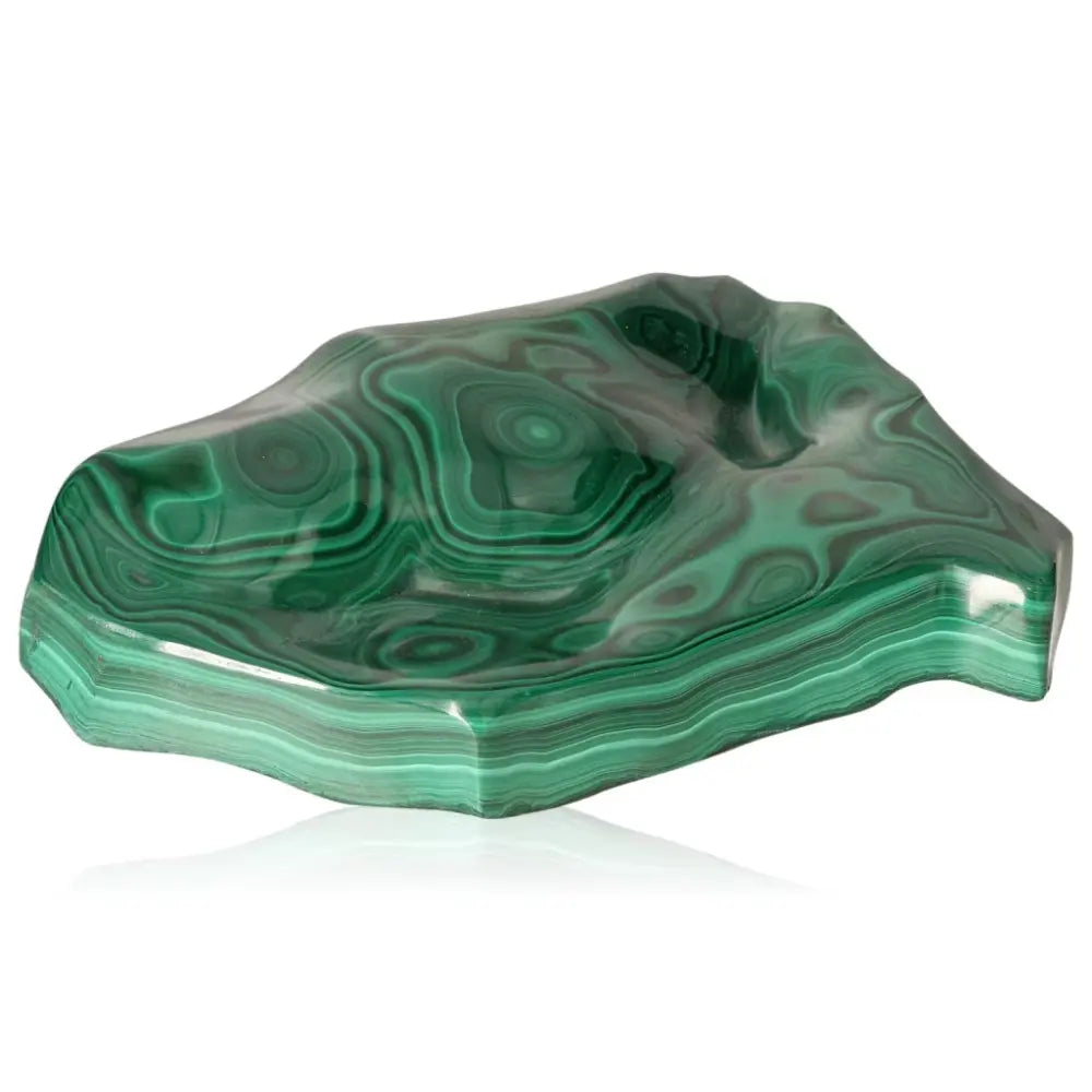 Polished malachite gemstone with mesmerizing green swirls, embodying tranquility and positivity.