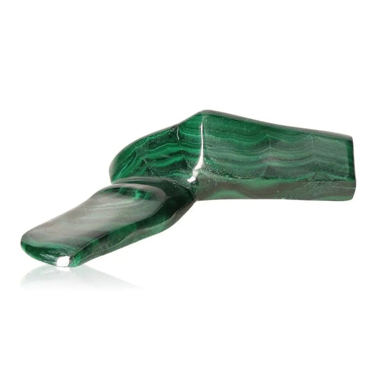 Polished green Malachite gemstone radiating soothing energy and transformative power on a white background.