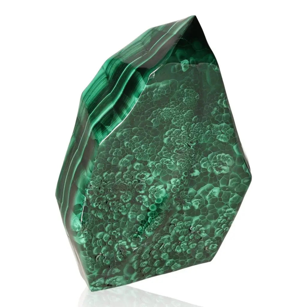 Polished malachite stone with vibrant green hues and natural patterns, known for its soothing and energizing properties.