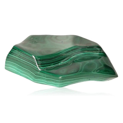 Polished malachite gemstone displaying vivid green patterns, symbolizing tranquility and empowerment.