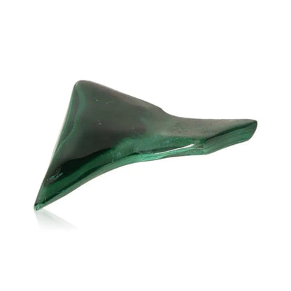 Malachite gemstone, vibrant green stone known for empowering courage and transforming fear, displayed on a white background.