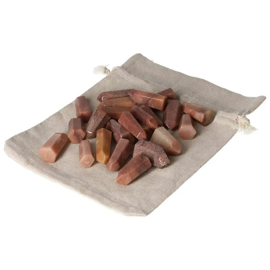 Mini Point Red Quartz Crystals 1 KG, 25 PCS, enhancing chakras and spiritual energy, on a beige pouch.