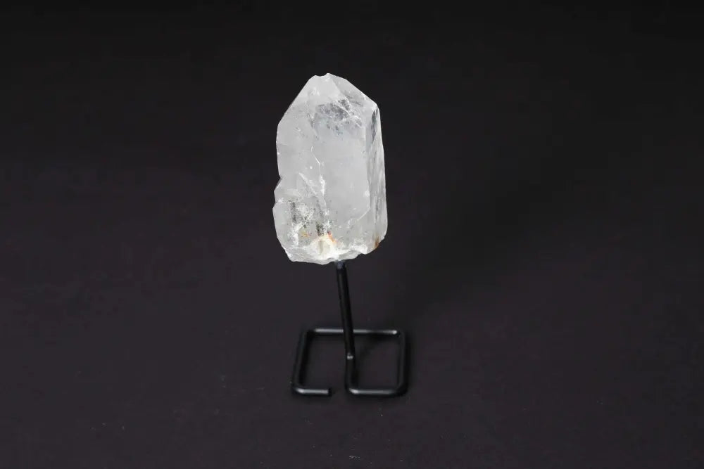 Natural Clear Quartz Point on stand, amplifying energy. Ideal for meditation and manifestation. Elegant display for any space.