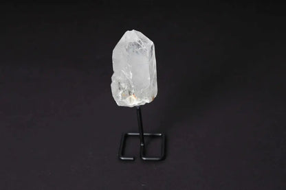Natural Clear Quartz Point on stand, amplifying energy. Ideal for meditation and manifestation. Elegant display for any space.