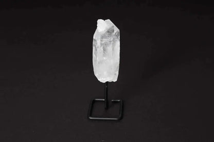 Natural Clear Quartz Point on black stand for energy amplification and clarity.