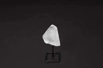 Natural Clear Quartz Point on Stand for energy alignment and meditation, elegantly displayed to amplify and illuminate space.