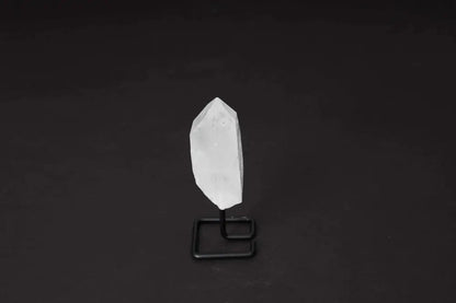 Clear Quartz point on stand, ideal for energy amplification and clarity, showcased on a modern display for home or meditation spaces.
