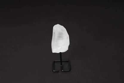 Clear Quartz Point on Stand, enhancing energy, clarity, and focus. Ideal for meditation, showcasing a refined design against a black backdrop.