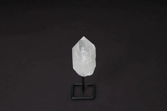 Natural Clear Quartz Point on modern stand for energy amplification and clarity, ideal for meditation and manifestation.