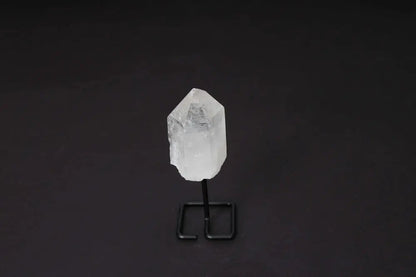 Natural Clear Quartz Point on a modern stand, ideal for meditation and energy work, amplifies clarity and intention.