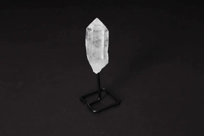 Natural clear quartz point on modern stand, perfect for amplifying energy and clarity in meditation or energy work.