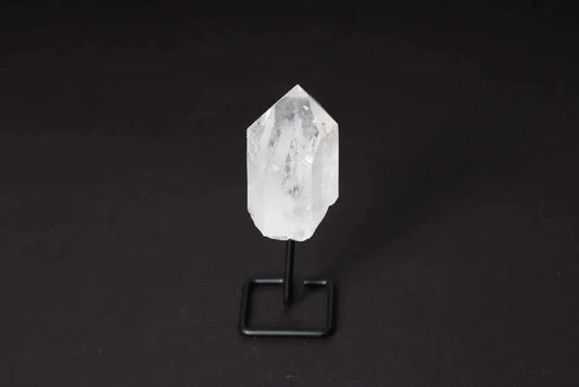 Natural Clear Quartz point on a stand, amplifying energy and clarity, ideal for meditation and energy work, with a modern, elegant design.