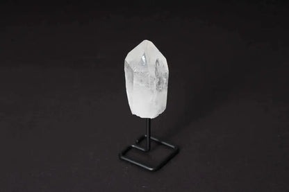 Natural clear quartz point on a stand, ideal for meditation, manifestation, and energy work, amplifying focus and clarity.