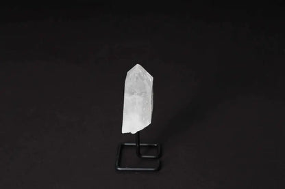 Clear Quartz Point on Stand for meditation and energy work, enhances focus and clarity, displayed against black background.
