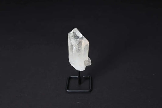 Clear Quartz Point on stand for energy amplification and clarity in meditation and manifestation.