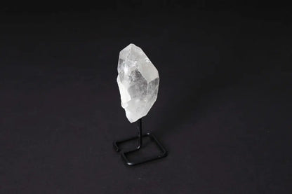 Natural Clear Quartz Point With Stand for energy amplification and alignment, elegantly displayed on a modern black stand.