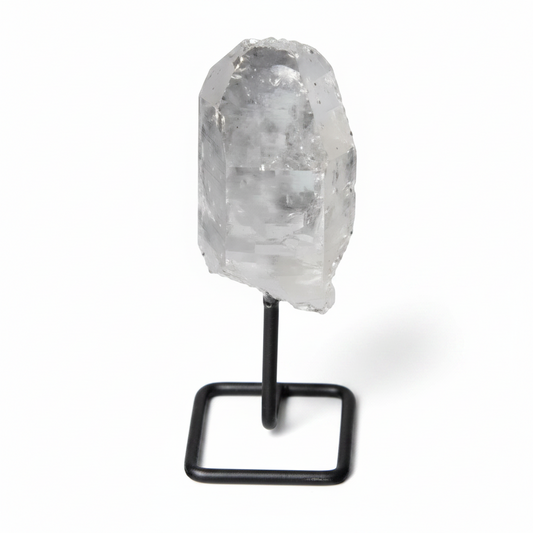 Natural clear quartz point on a stand, perfect for meditation and energy alignment, enhancing clarity and focus in any space.