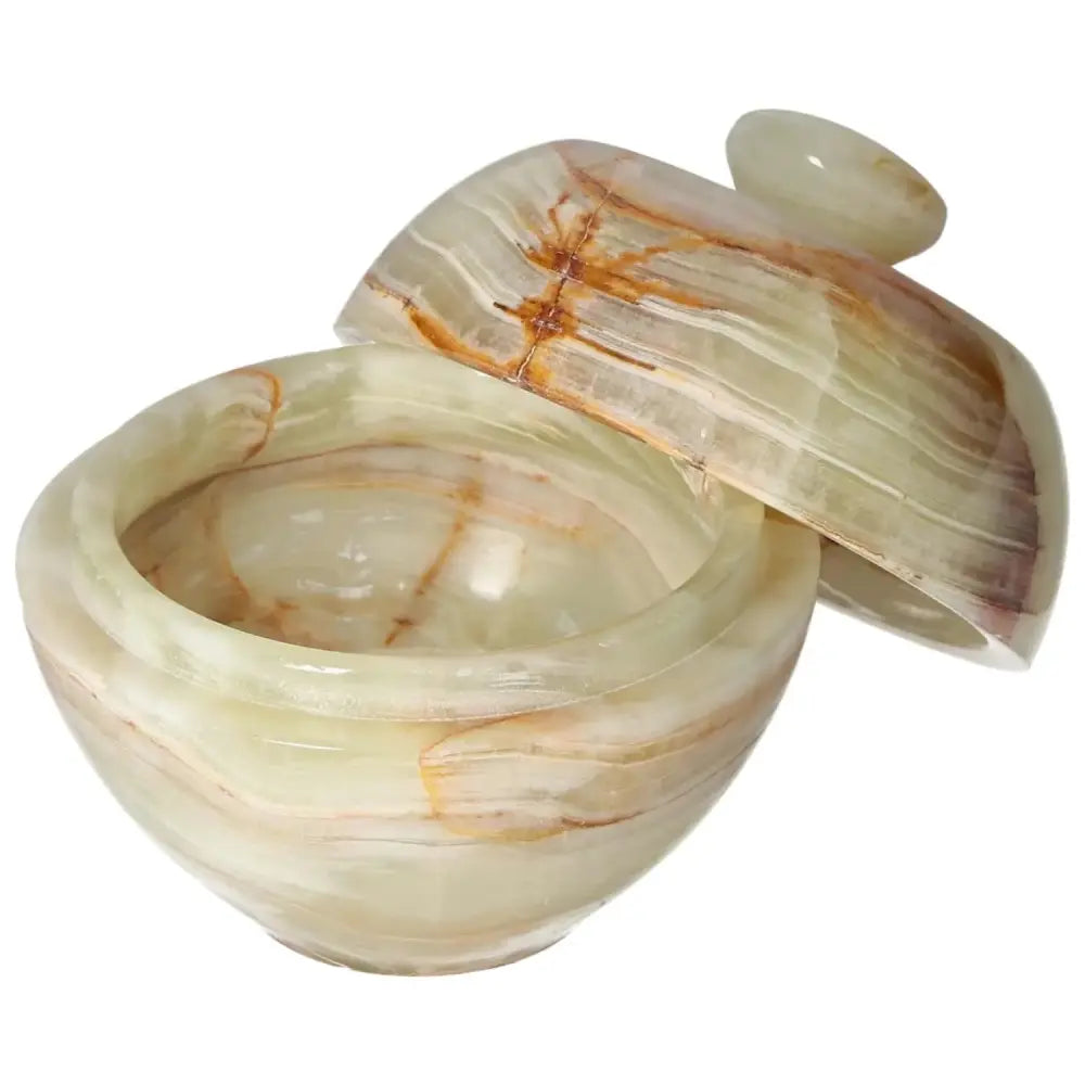 10cm Onyx Bowl with Lid showcasing elegant veining and polished finish, capturing light with its refined craftsmanship and unique design.