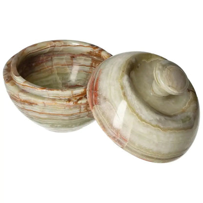 Onyx 10cm bowl with lid showcasing unique veining and smooth polish, reflecting light to enhance home décor elegance.