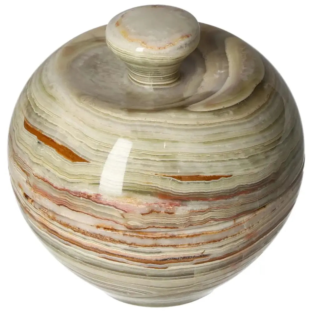Onyx 10cm bowl with lid displaying natural veining and polished finish, adding elegance to home décor while reflecting light beautifully.