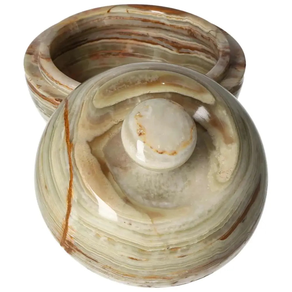 Onyx bowl with lid, featuring polished surface and unique veining, ideal for décor enhancement and luxury aesthetics.