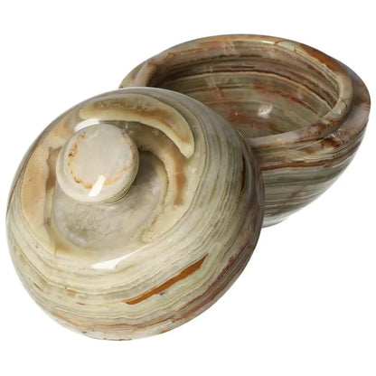 Elegant 10cm onyx bowl with lid showcasing unique veining and translucent beauty, perfect for elevating home décor with sophistication.