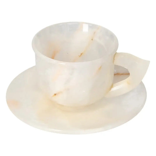 Luxurious off-white onyx coffee cup and plate set, showcasing unique variations in tone and polished elegance.