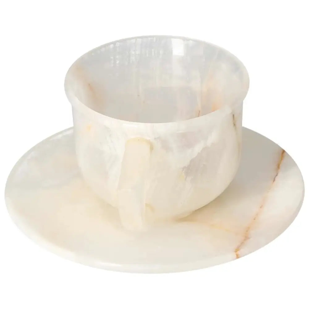 Elegant off-white onyx coffee cup and plate set with unique patterns, showcasing natural beauty and polished elegance, enhancing any space.