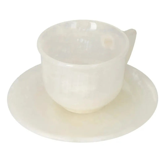 Elegant off-white onyx coffee cup and plate set with unique patterns, reflecting soft ambient light for a luxurious coffee experience.