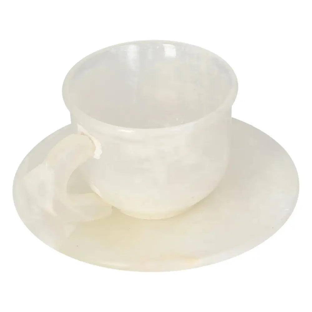 Elegant onyx coffee cup and plate set with polished off-white stone finish, showcasing unique natural patterns.