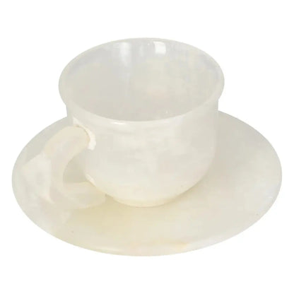 Elegant onyx coffee cup and plate set with polished off-white stone finish, showcasing unique natural patterns.