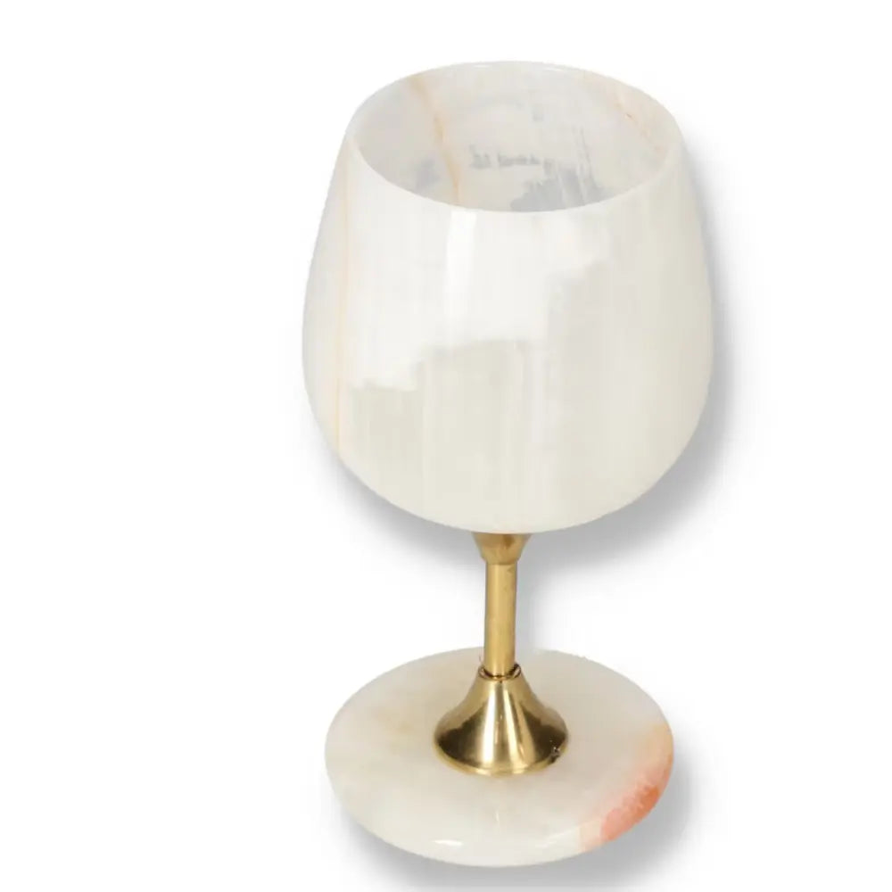 Elegant onyx wine glass with unique veining, polished to perfection for sophisticated occasions.