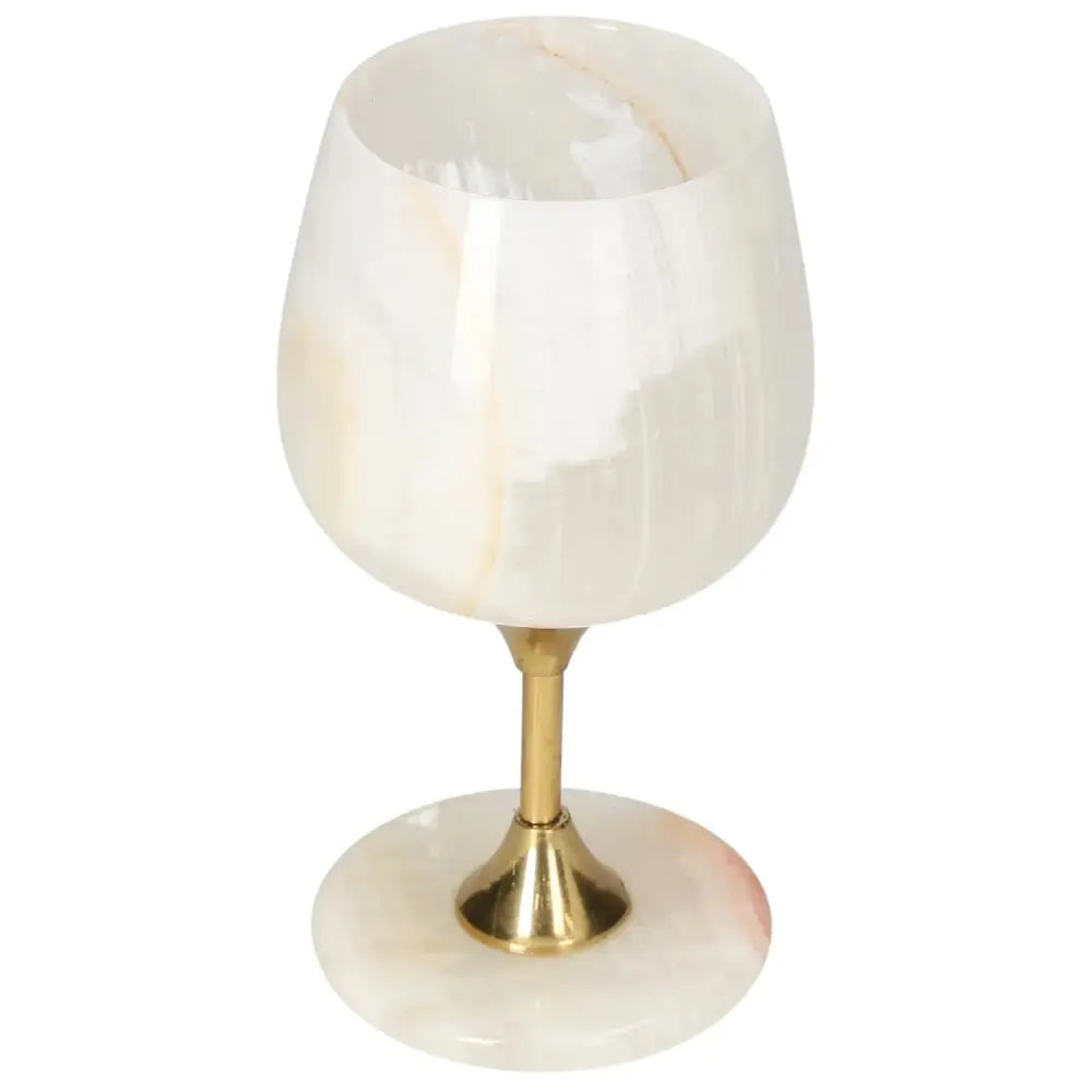 Exquisite off-white onyx wine glass with unique veining, featuring a polished surface and elegant brass stem, perfect for fine dining.