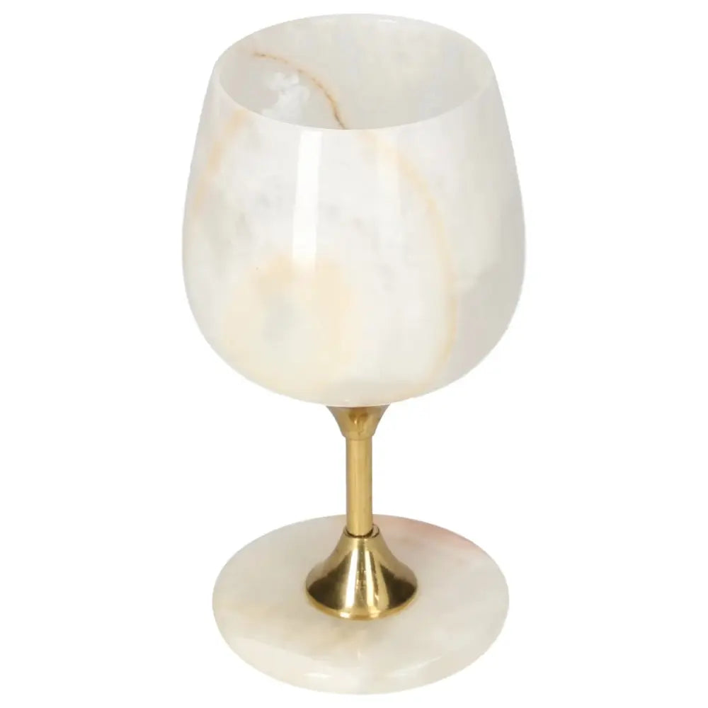 Exquisite off-white onyx wine glass with gold stem, showcasing unique veining and polished surface for elegant occasions.