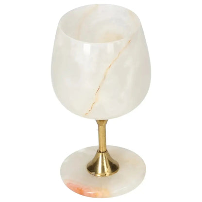 Exquisite onyx wine glass with unique veining, elegant polished surface, and brass stem, perfect for sophisticated occasions.