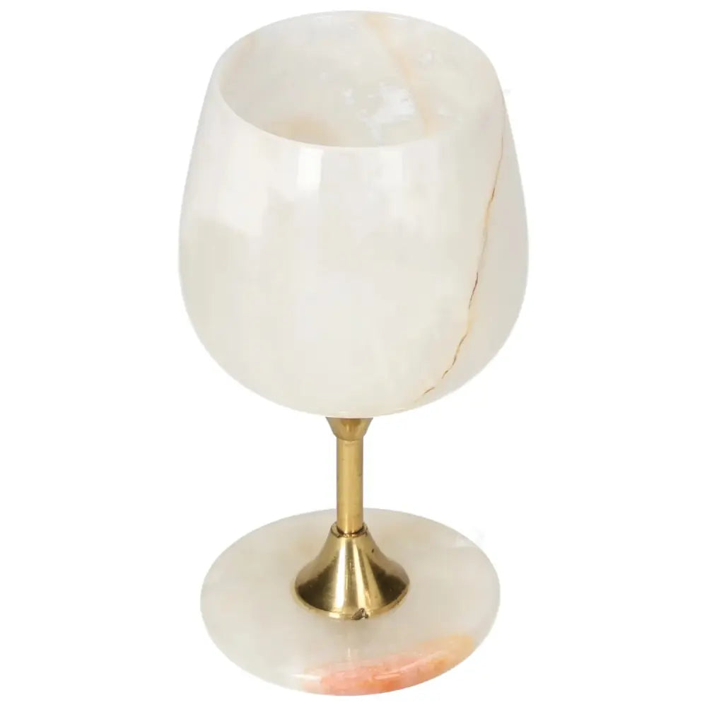 Elegant onyx wine glass with unique veining, polished surface, and gold stem, perfect for sophisticated occasions.