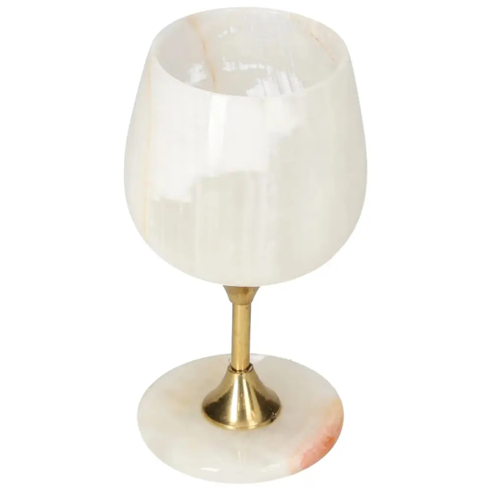Elegant onyx wine glass with brass stem, showcasing unique variations in off-white hues and natural veining for sophisticated occasions.