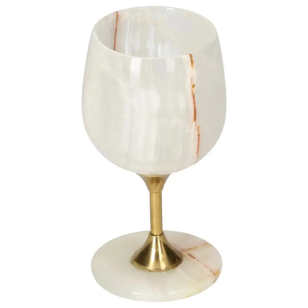 Elegant onyx wine glass with unique color veining, set on a polished brass stem, emphasizing sophistication and natural beauty.