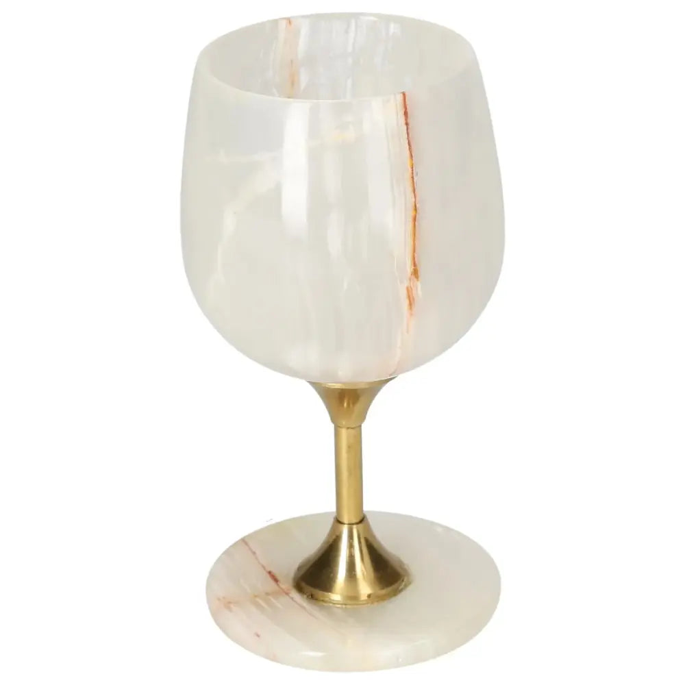 Exquisite off-white onyx wine glass with natural veining and polished finish, set on a gold stem, combining elegance and sophistication.