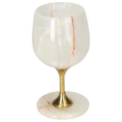 Exquisite off-white onyx wine glass with natural veining and polished finish, set on a gold stem, combining elegance and sophistication.